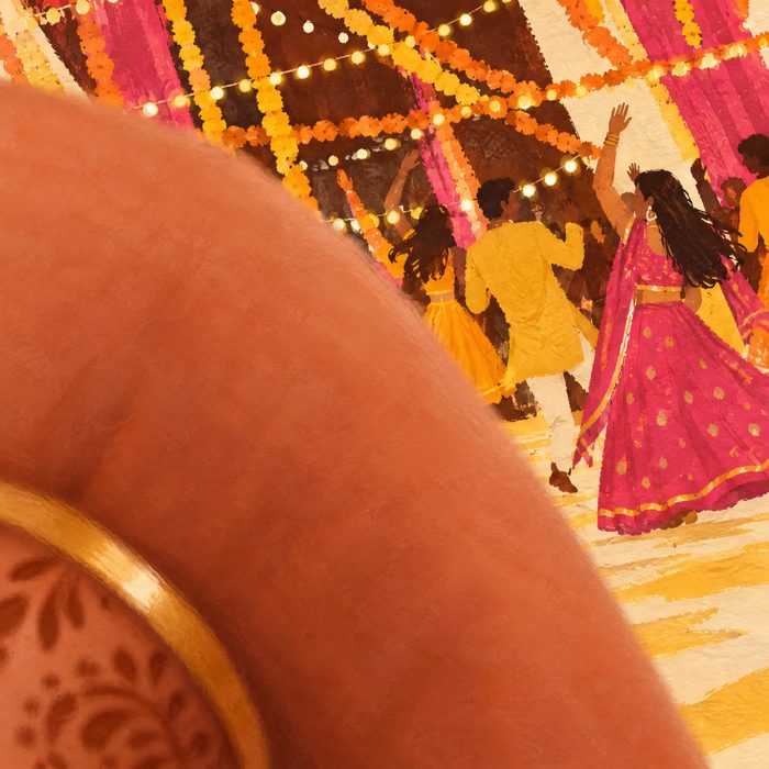 A blurry sangeet photo with a thumb over the lens